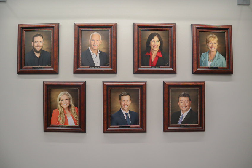 Littleton City Council members' portraits seen in the city's town hall.